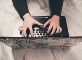Hands working on a laptop